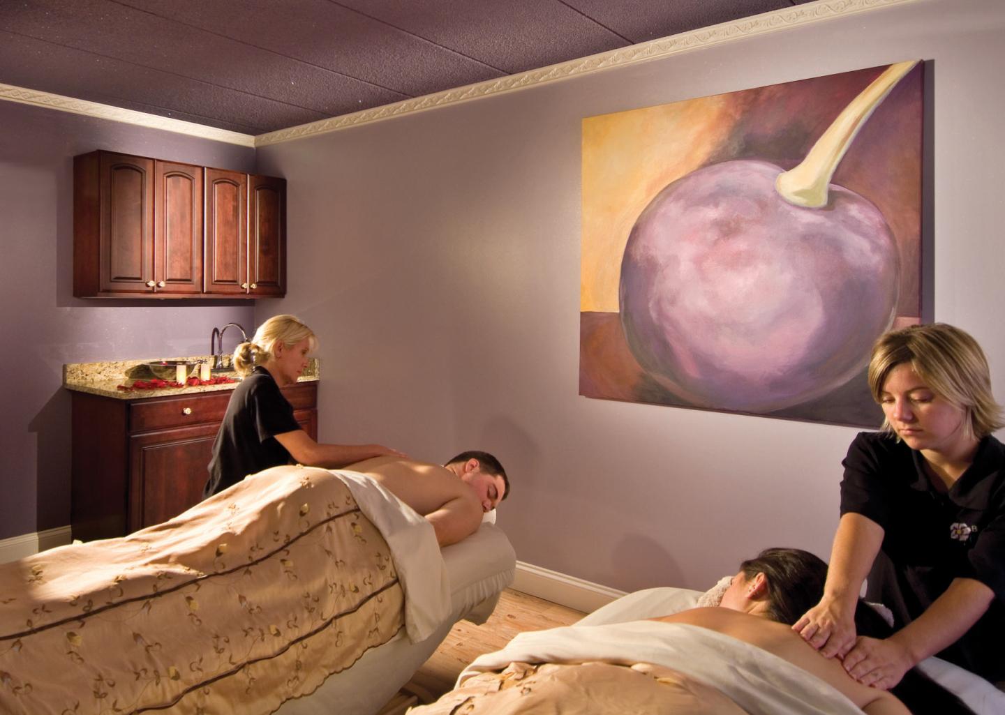 Interior of spa treatment room with two people each getting a massage 