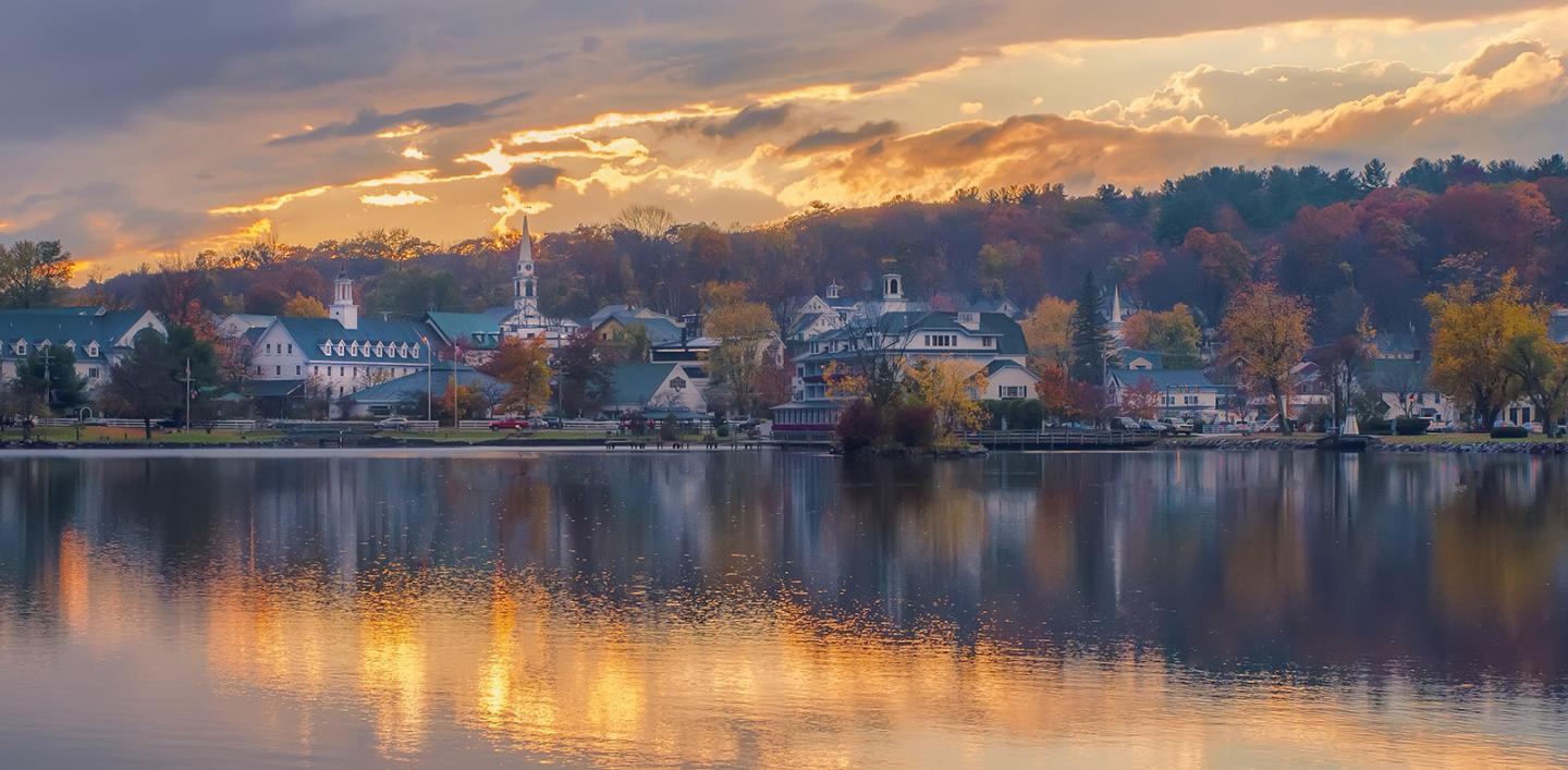 sunset view of town against a lake