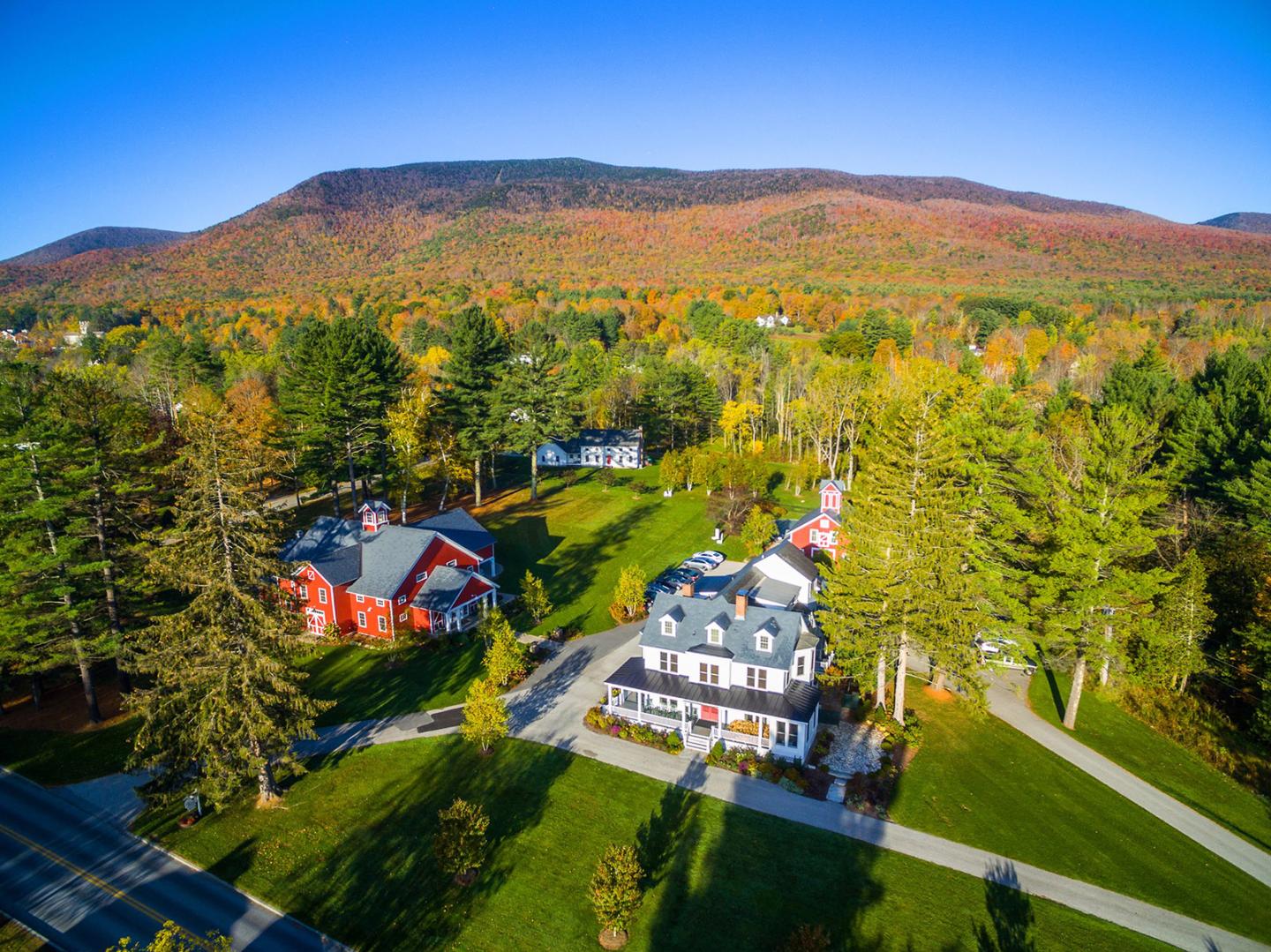 Aerial view of beautiful mountain scape in the fall with houses in the foreground