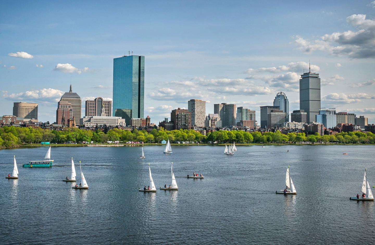 Beautiful view of sailboats on the water against a city on the shore