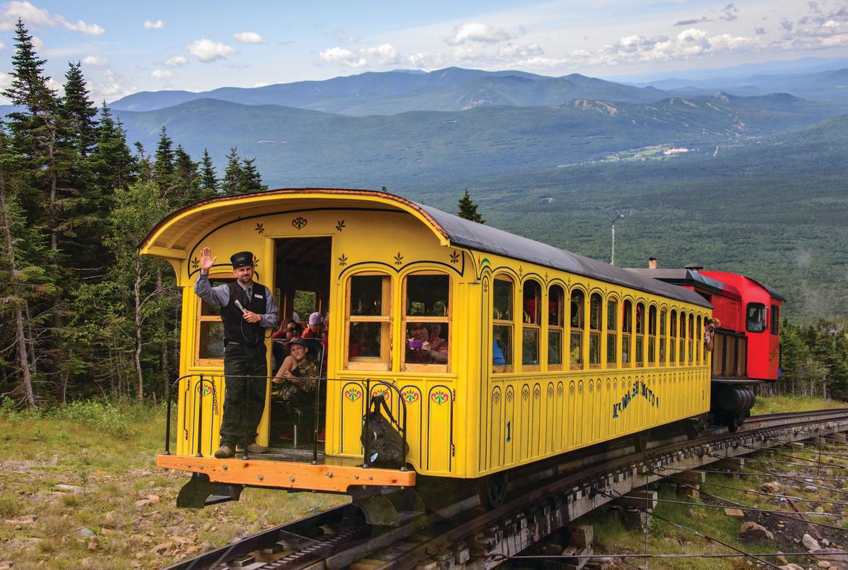 Train car on railway with mountains in the backdrop