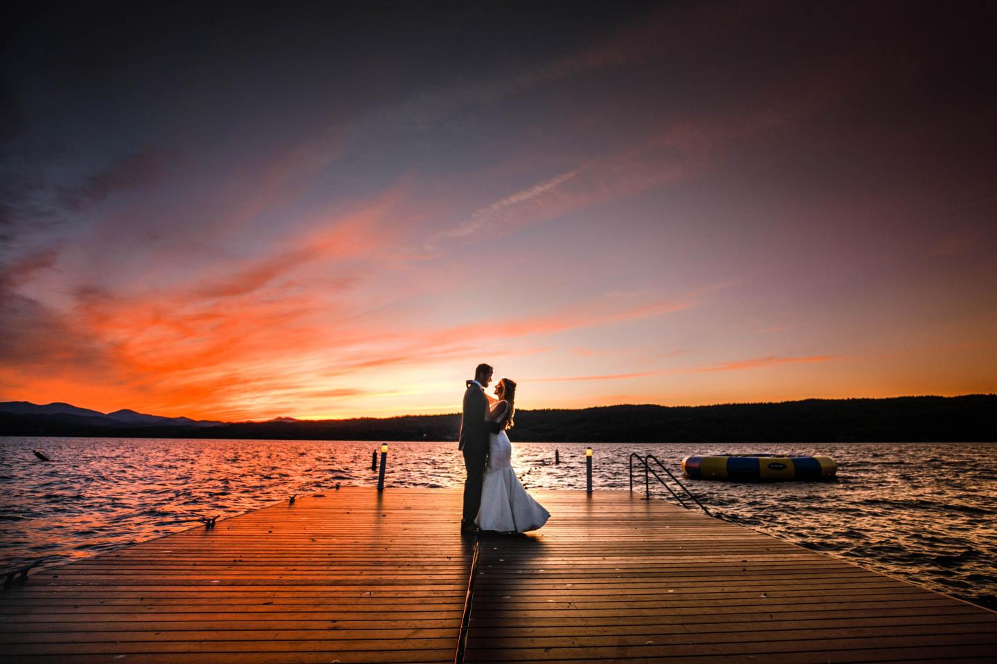 Wedding Couple Dancing on Swim Dock at sunset: Photo by Sabin Gratz