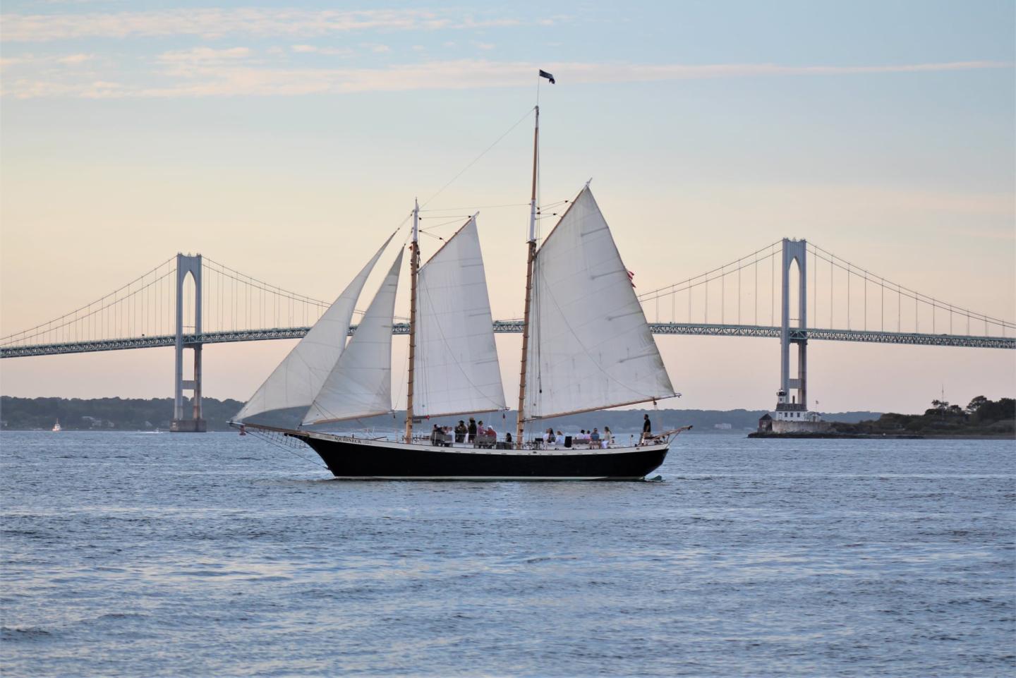 Sailboat on the water with bridge in the background