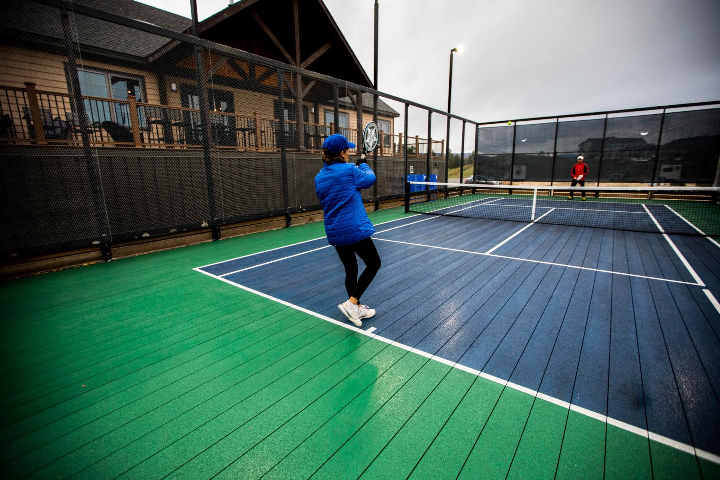 a woman playing platform tennis