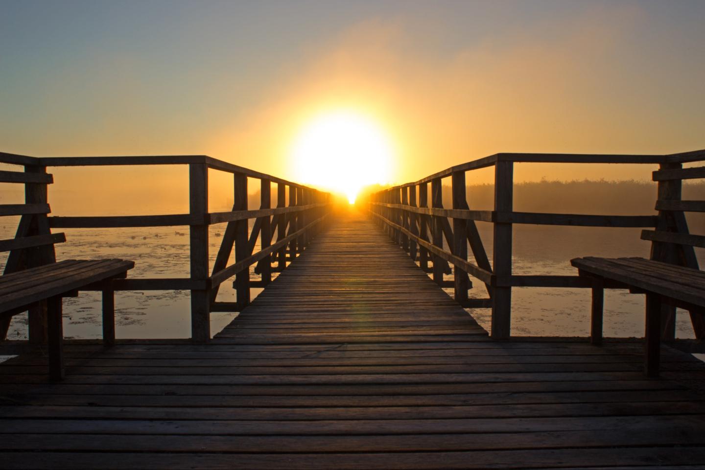 Sunset on boardwalk over the ocean