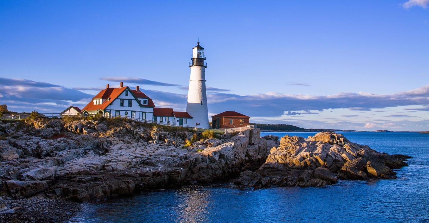 Lighthouse on cliff above ocean
