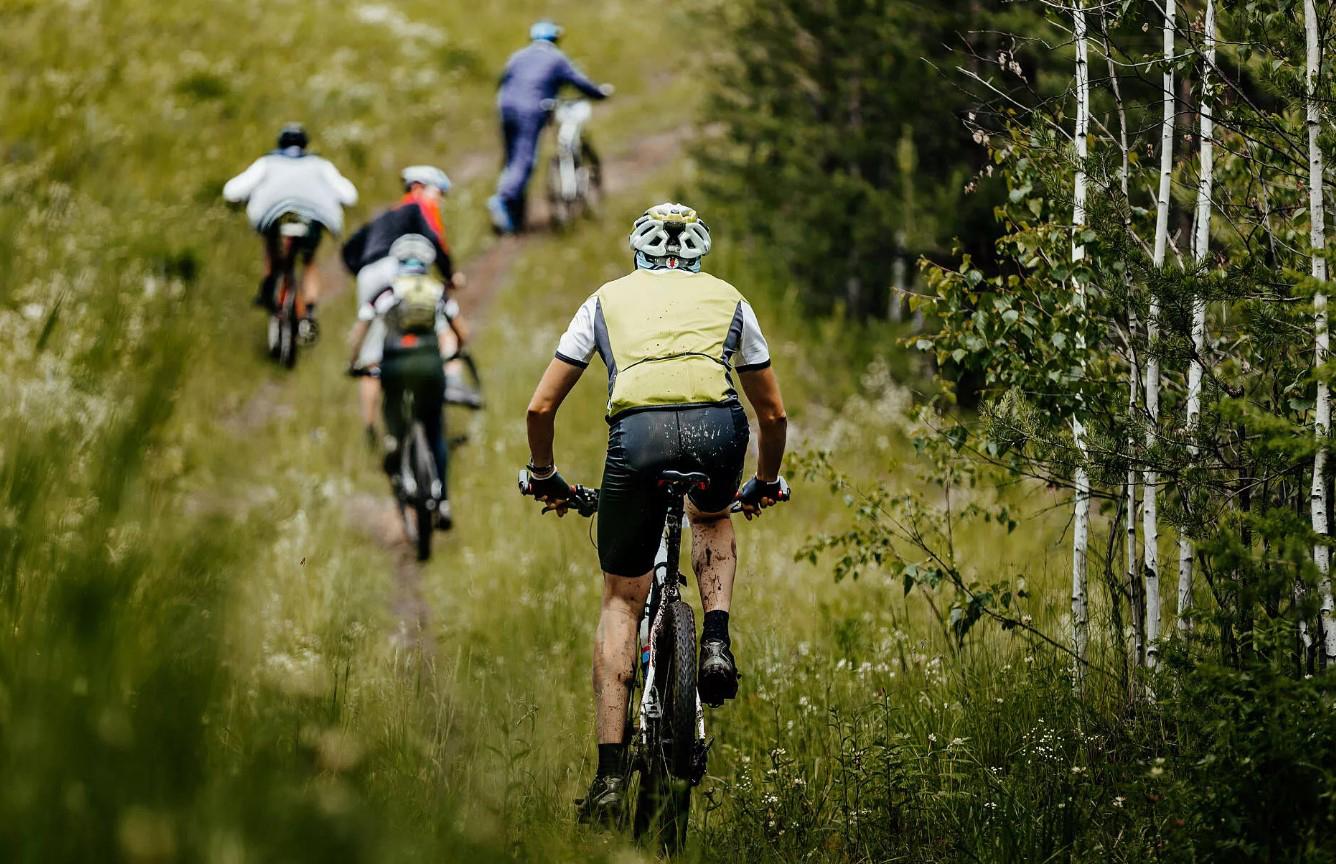 Group of mountain bikers riding down a trail