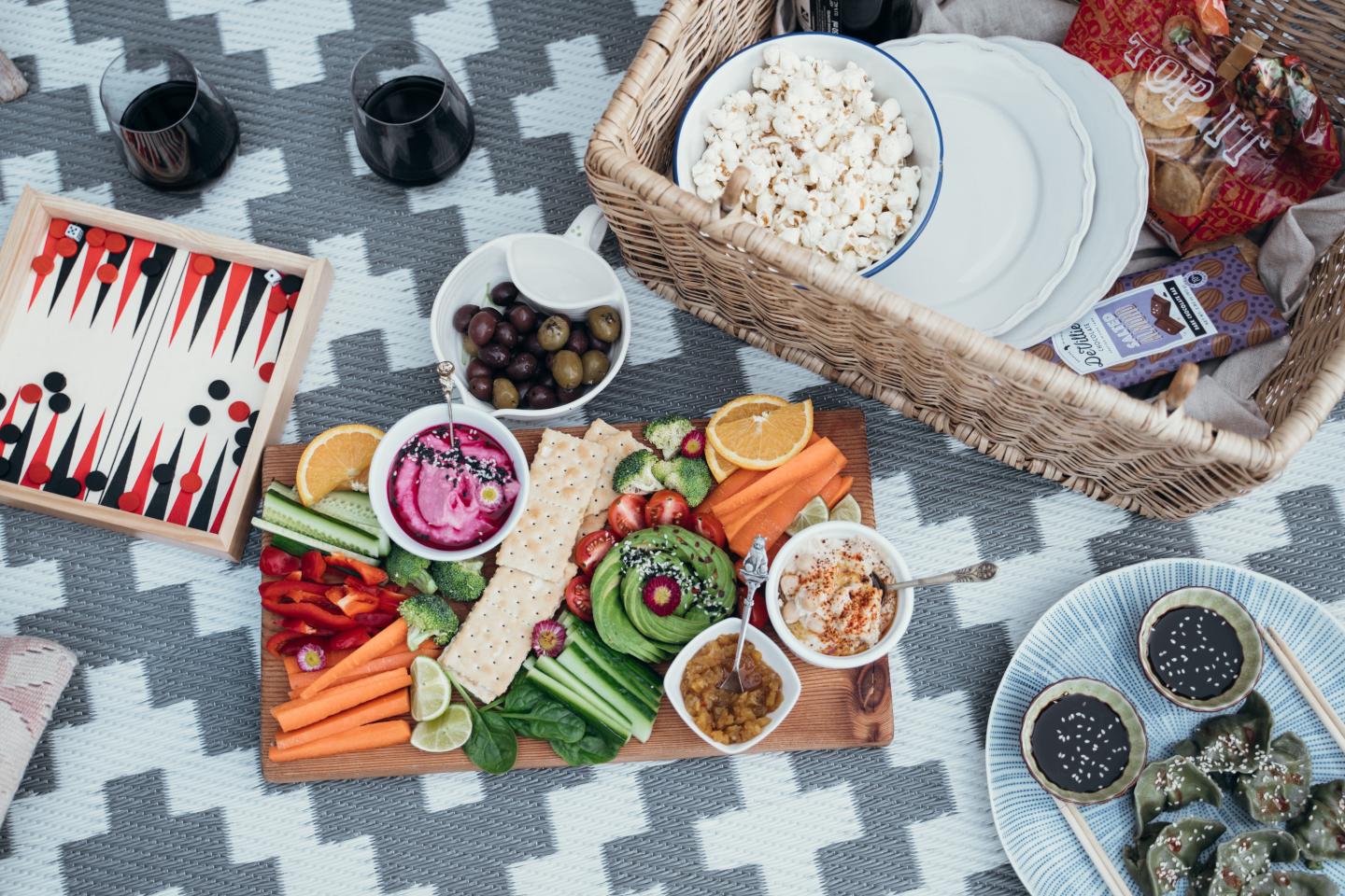 Snacks and games spread out on a blanket