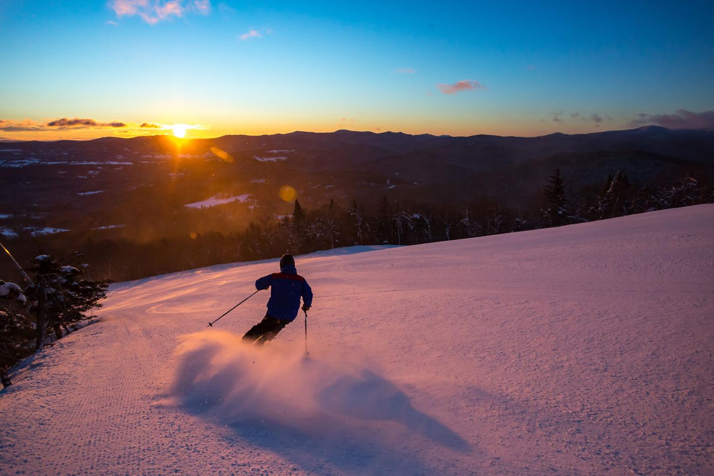 Skier with sunrise in the foreground