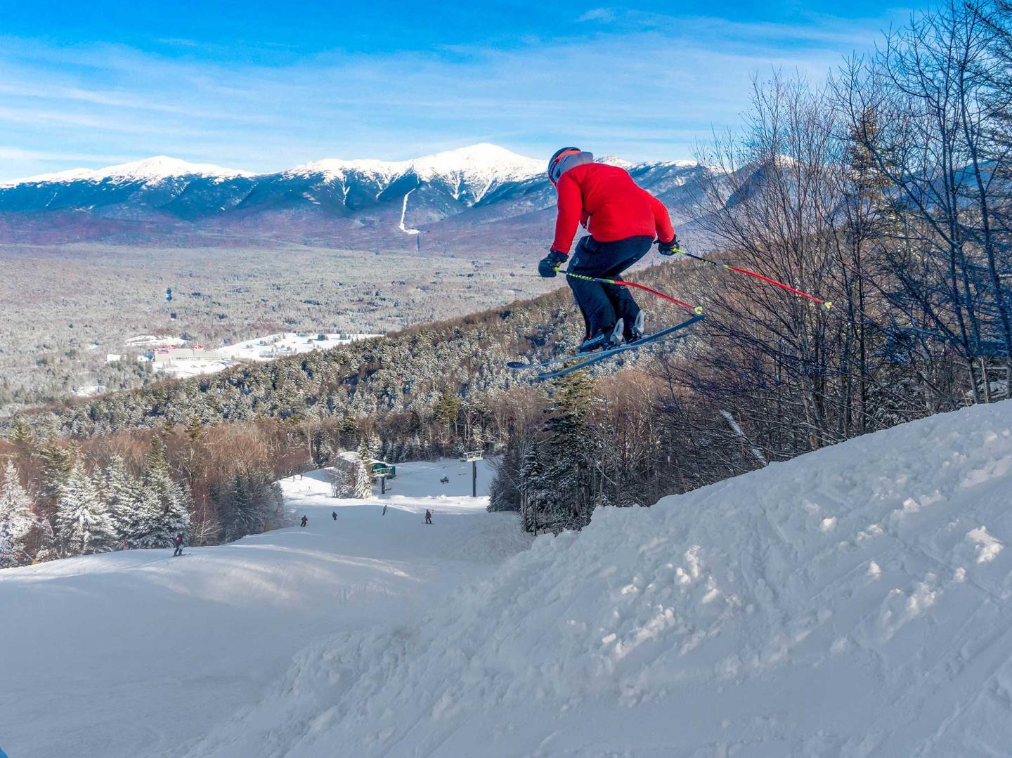 Skier jump in the air on a bluebird day
