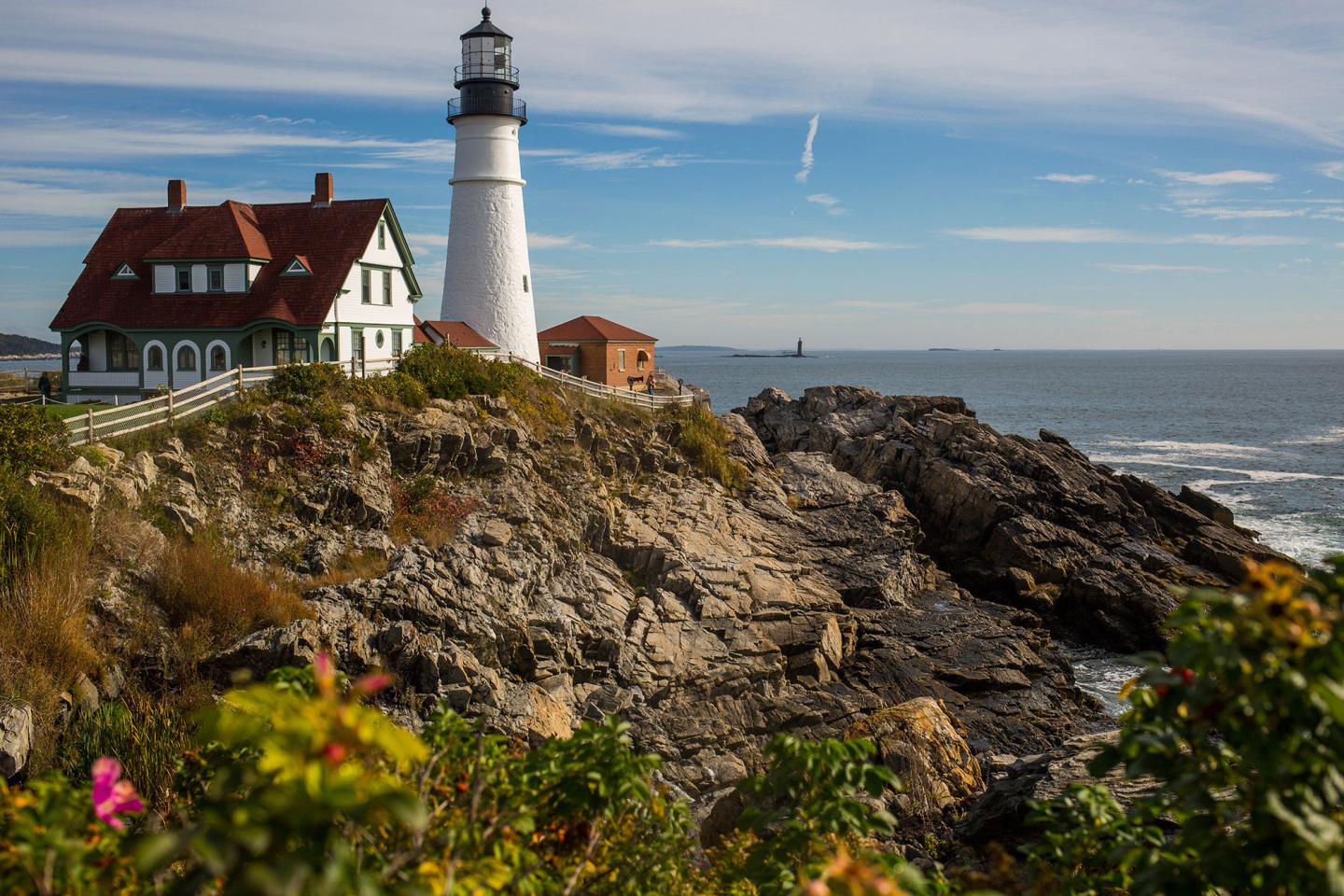Lighthouse on cliff above ocean