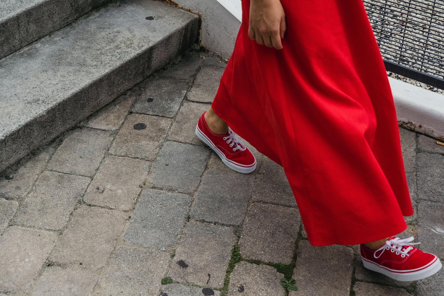 Close up of red shoes walking on sidewalk