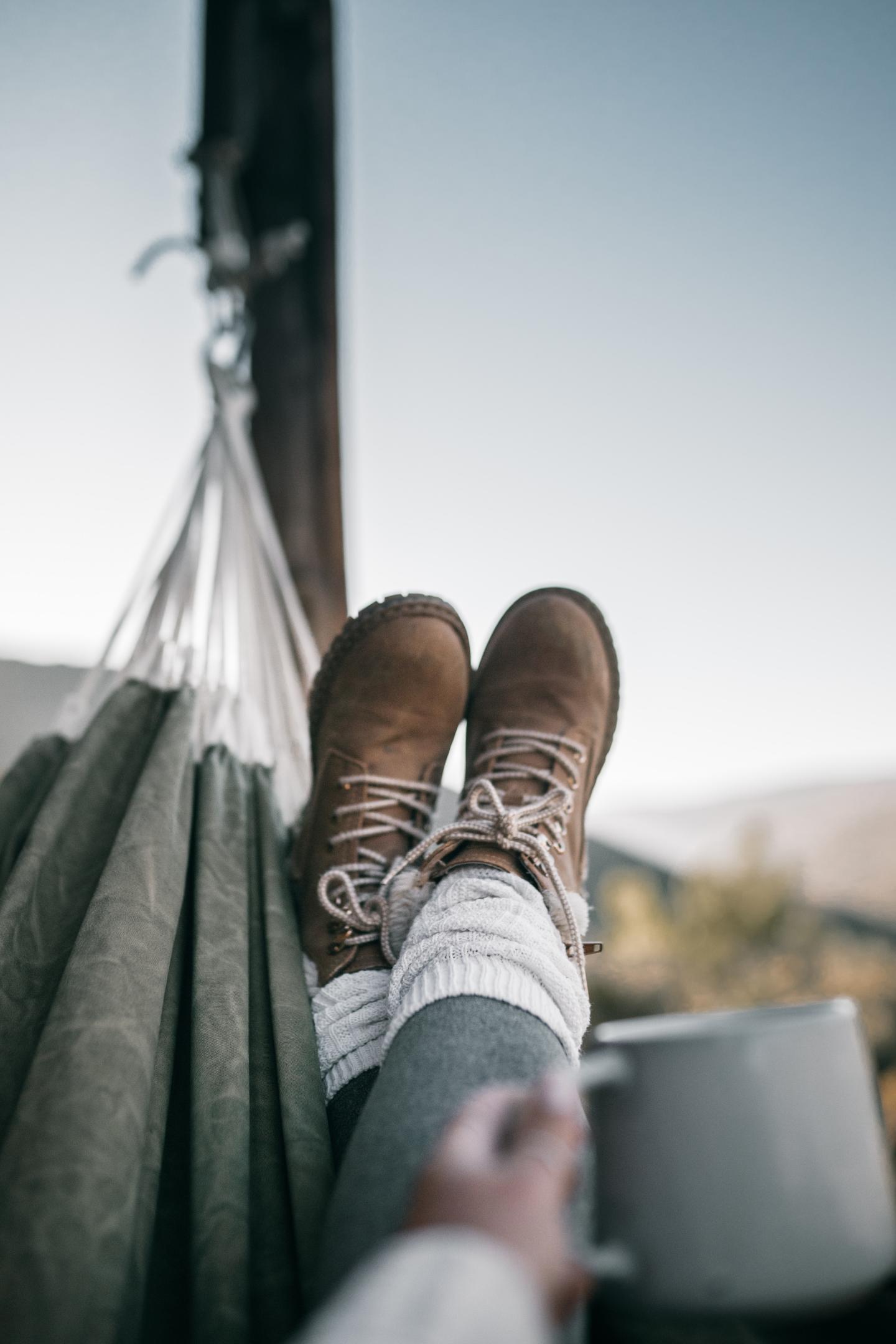 Relaxing view from hammock with hiking boots