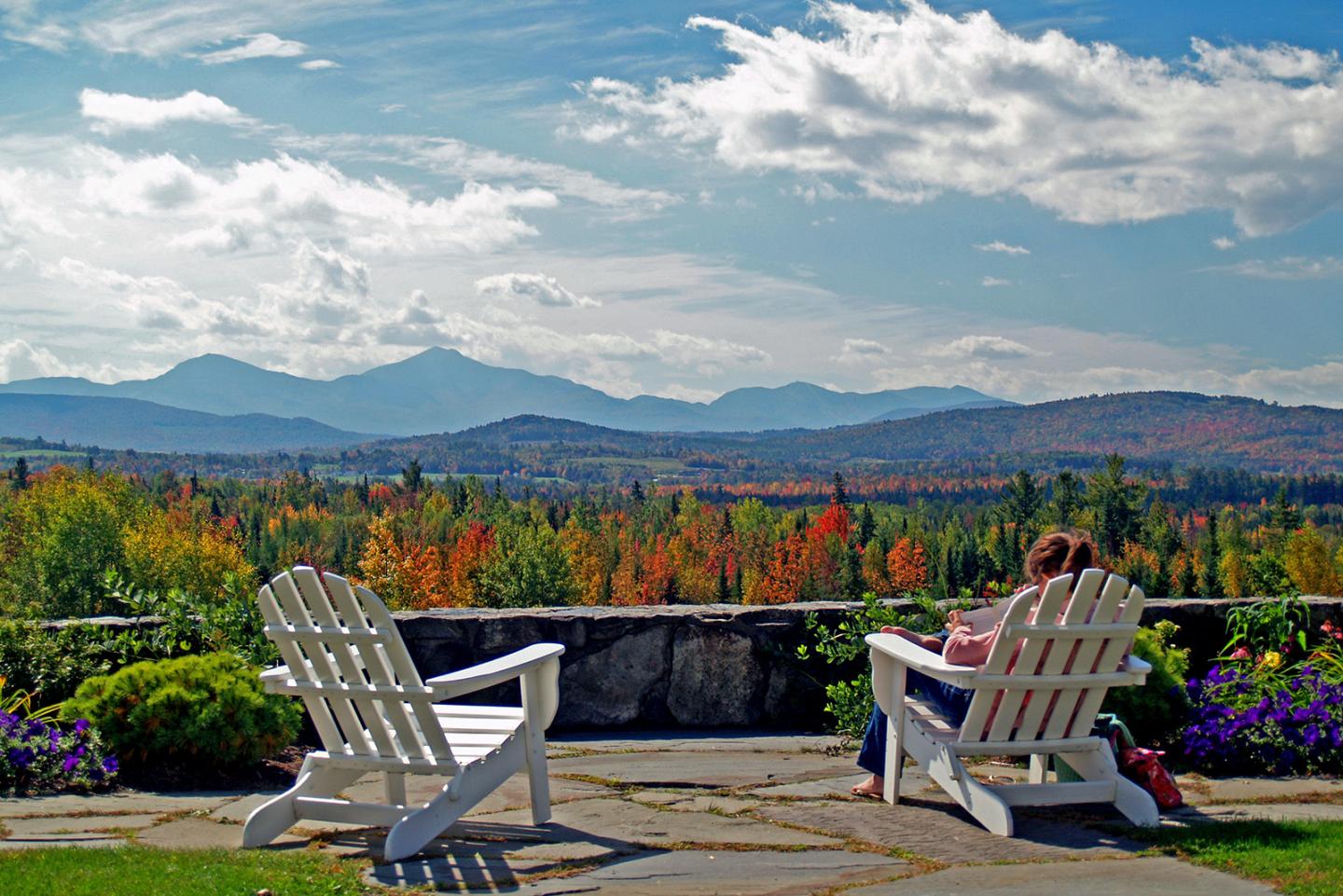 two chairs set up to look over a scenic mountain view in the fall