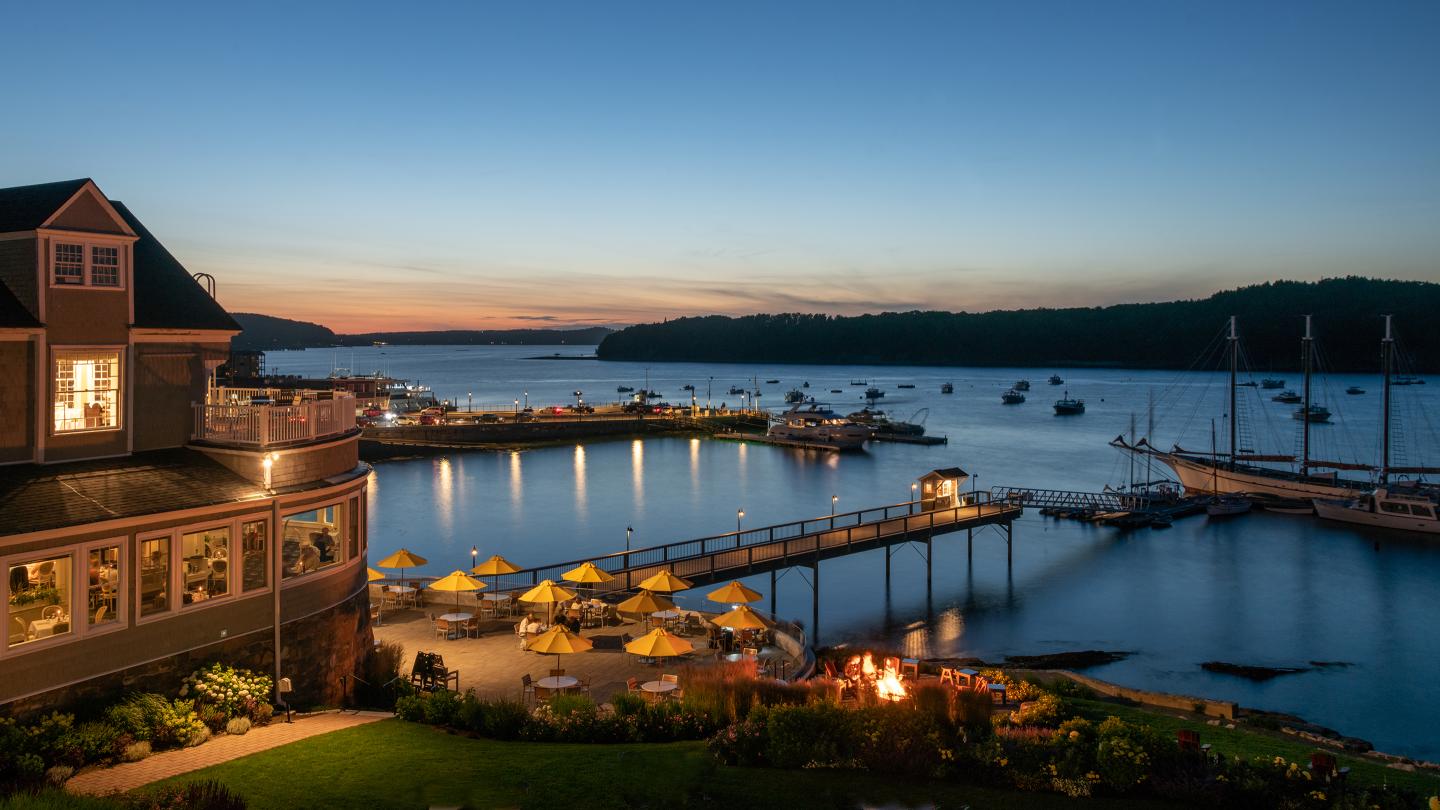Evening view of the Terrace Grill as seen from a Main Inn Guest Room balcony with views of the pier and oceanfront.