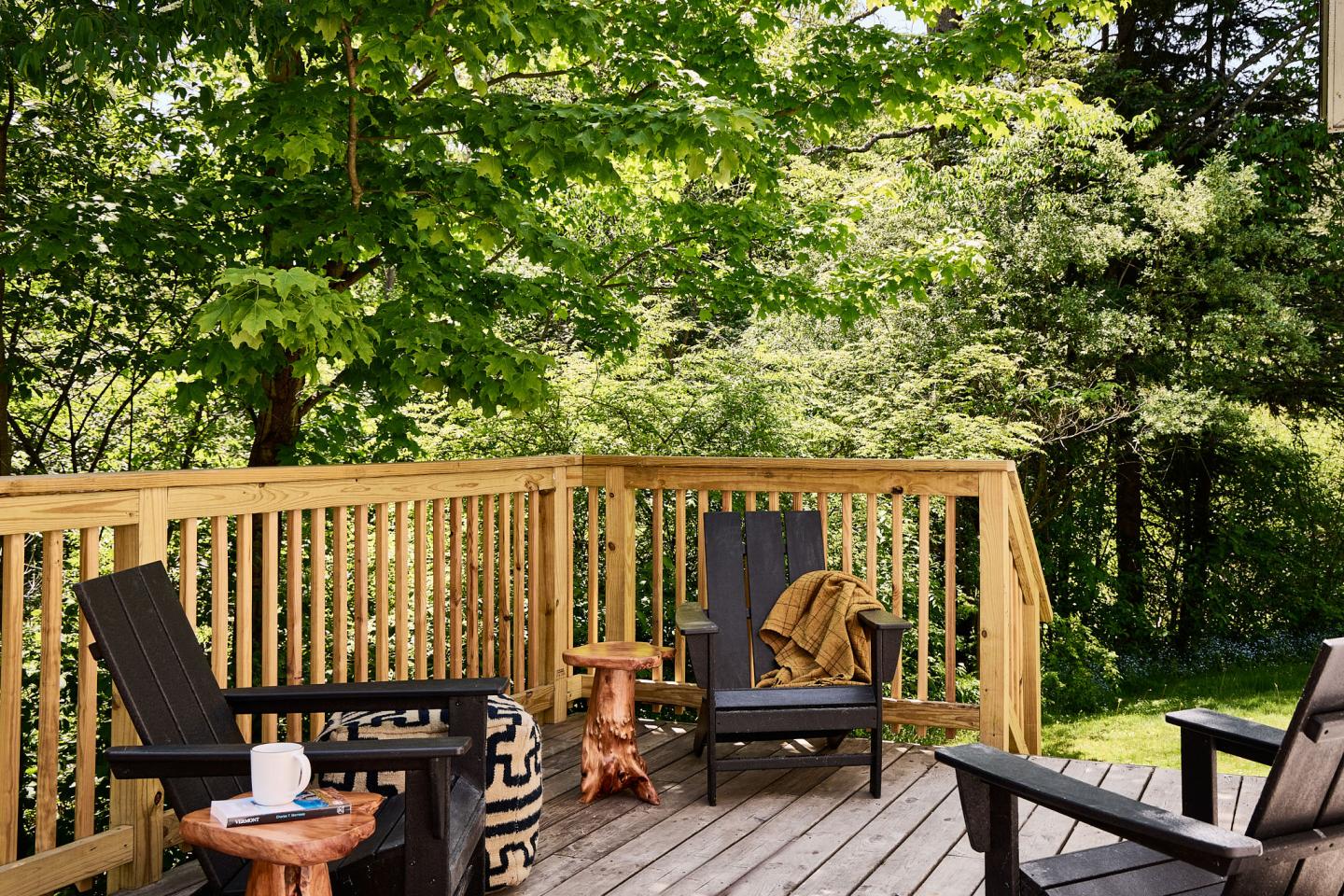 Guest room porch with adirondack chairs at Bluebird Cady Hill Lodge
