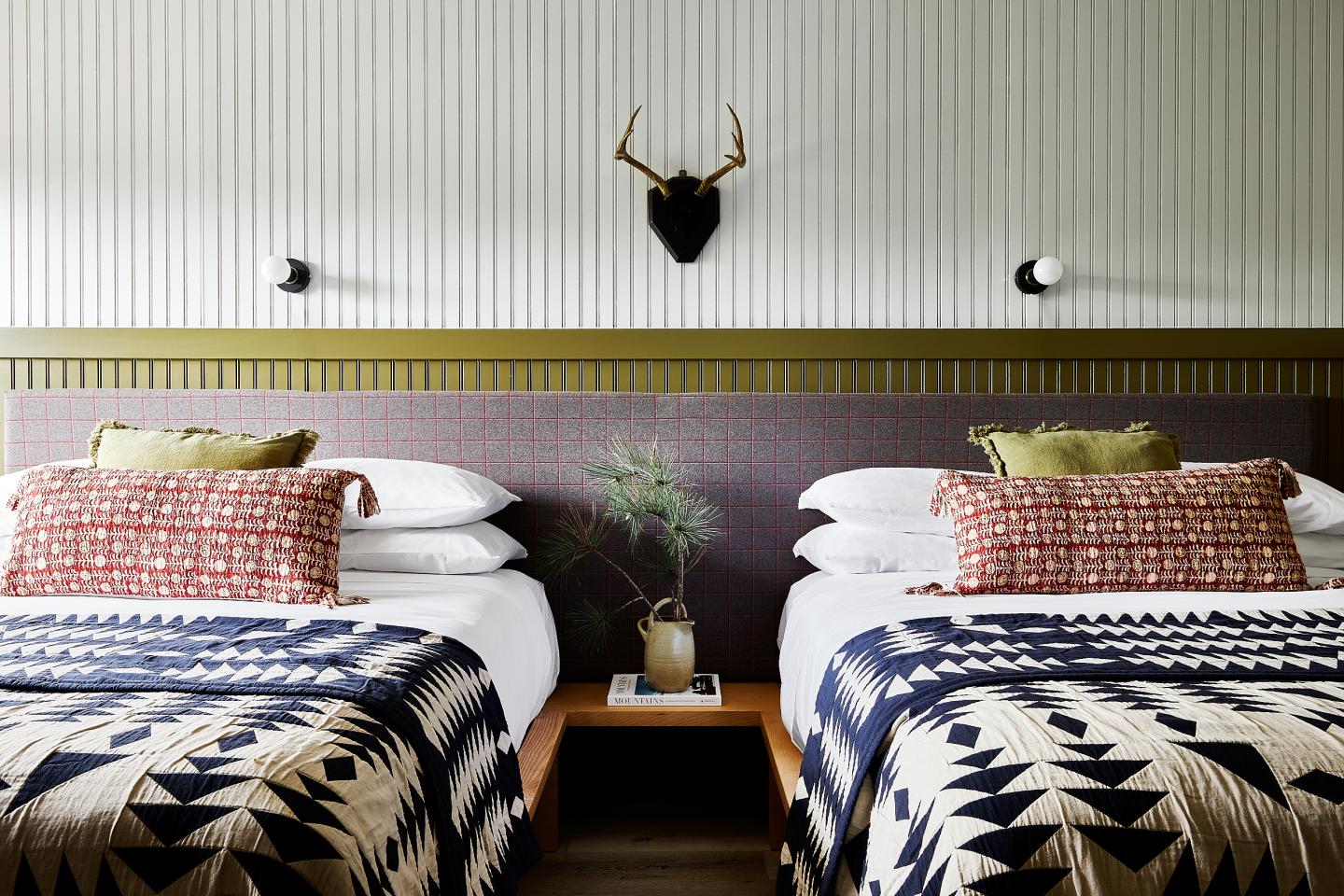 Double queen beds inside a guest room at Bluebird Sunapee