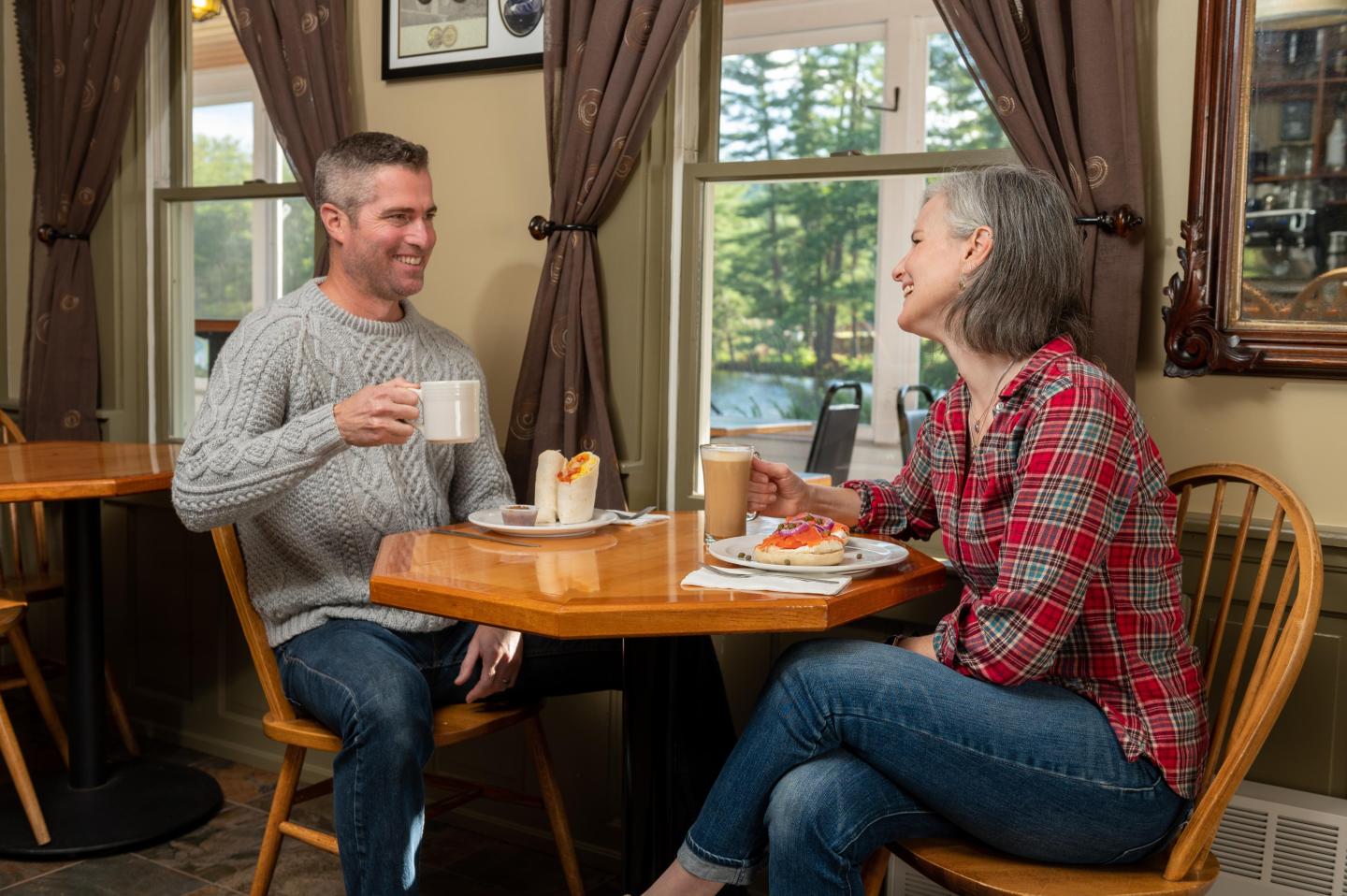A couple enjoying breakfast and coffee in Traditions Café at Purity Spring Resort