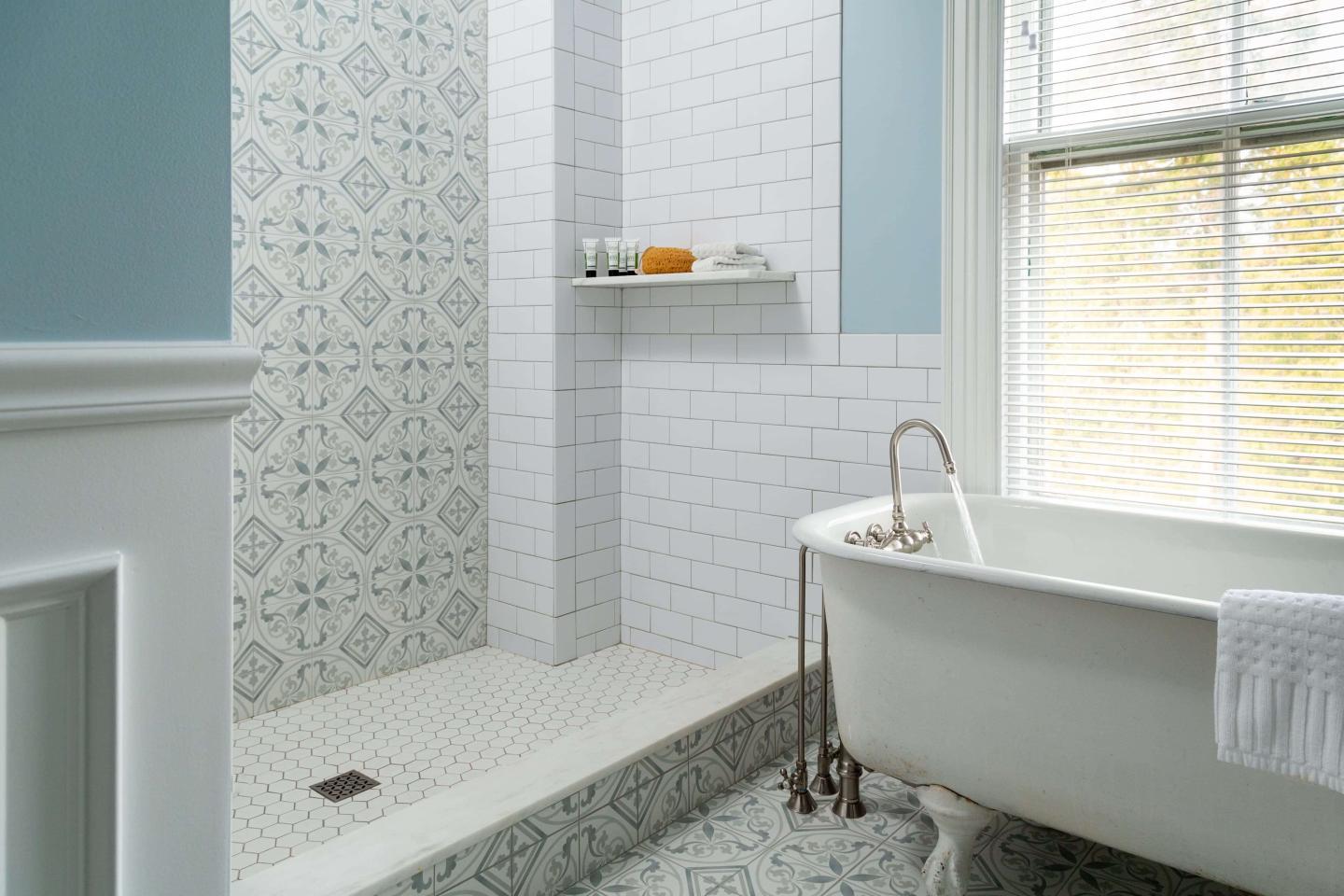 newly restored bathroom with a clawfoot tub and extra large rain shower