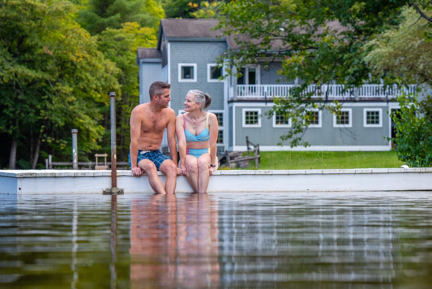 Couple enjoying sitting on dock and the lake at Purity Spring Resort