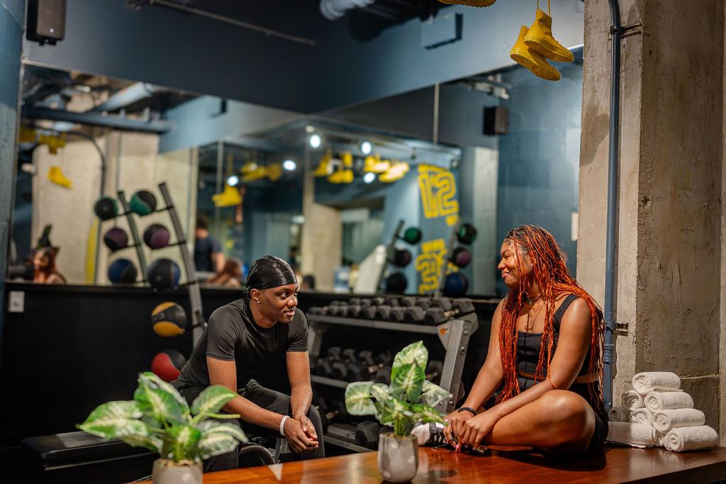 Male and Female sitting in the gym at The Revolution Hotel