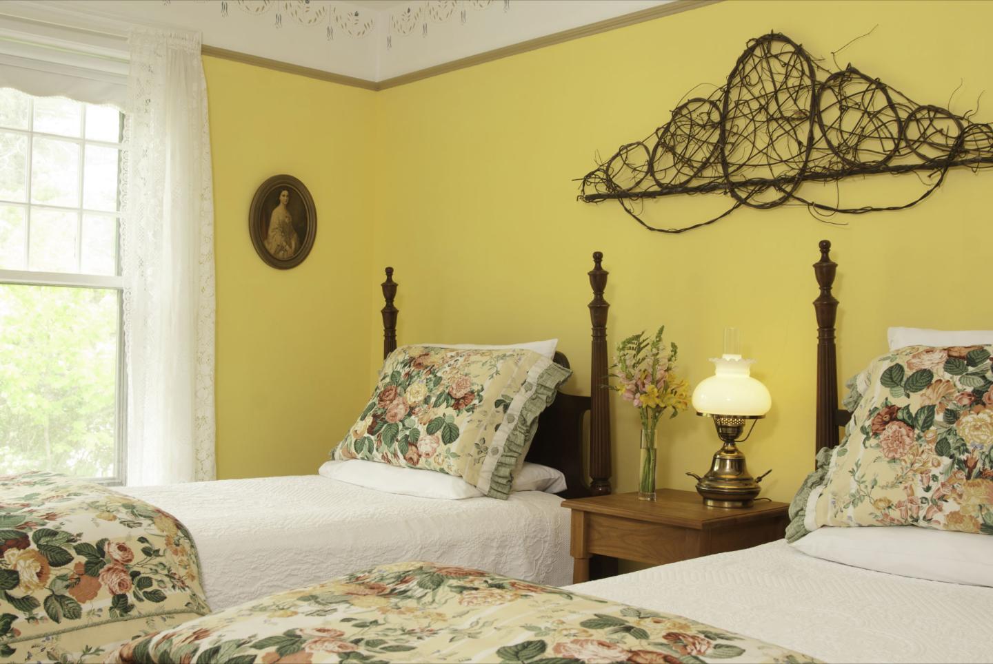 Reverend Warren's Room. Facing south, this sun-filled room offers an antique vanity, a comfy chair for relaxing and a small TV.