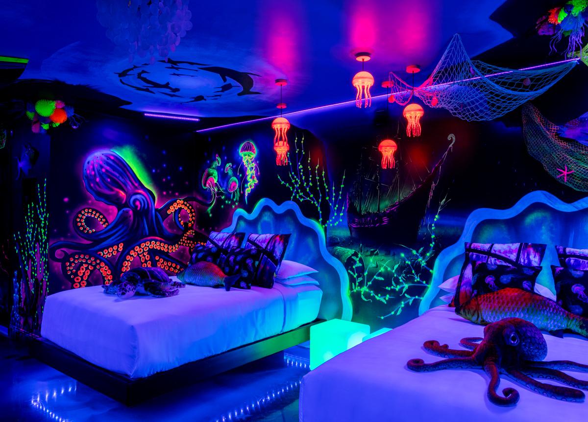 Glow in the dark harbor themed guest room at The Cove Hotel in Salem, MA