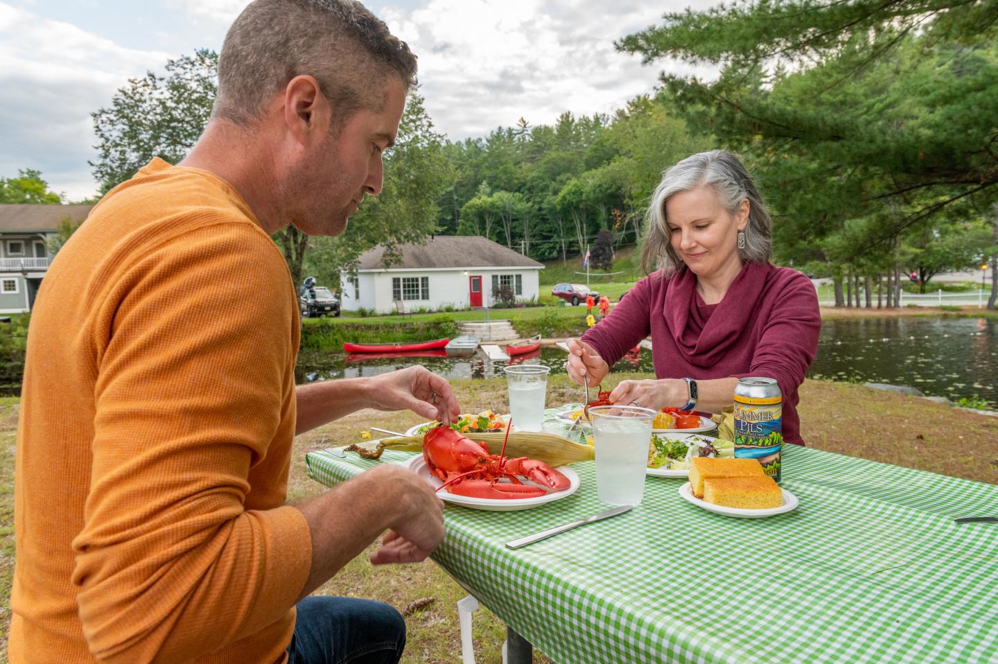 A couple enjoying the Lobster Cookout at Purity Spring Resort
