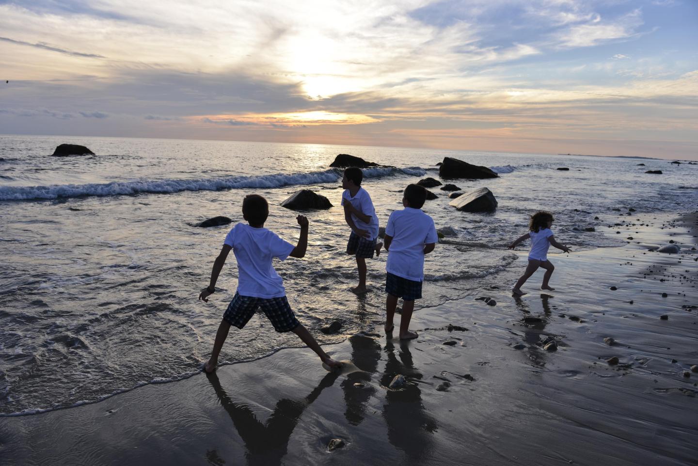 Kids throwing rocks on Massachusetts Beach