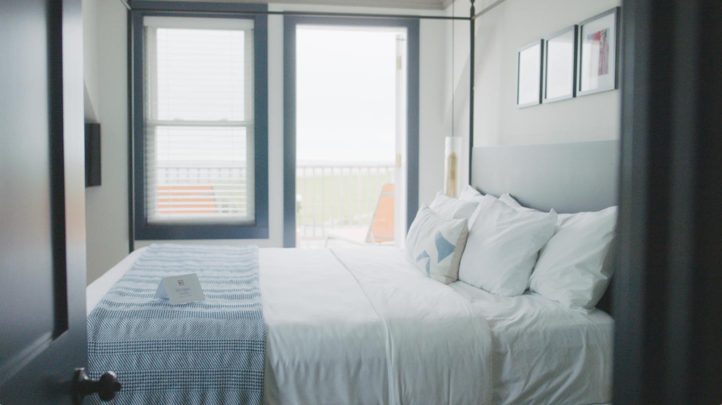 Bed with balcony and ocean view
