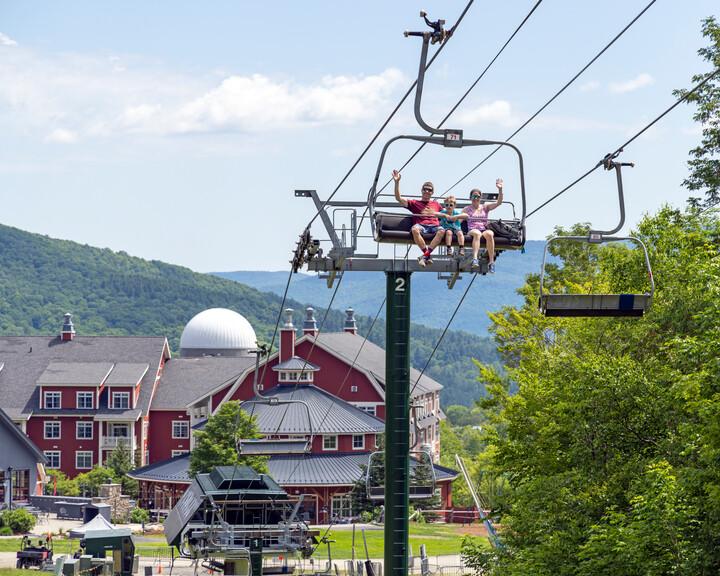 Family waving on a scenic lift ride