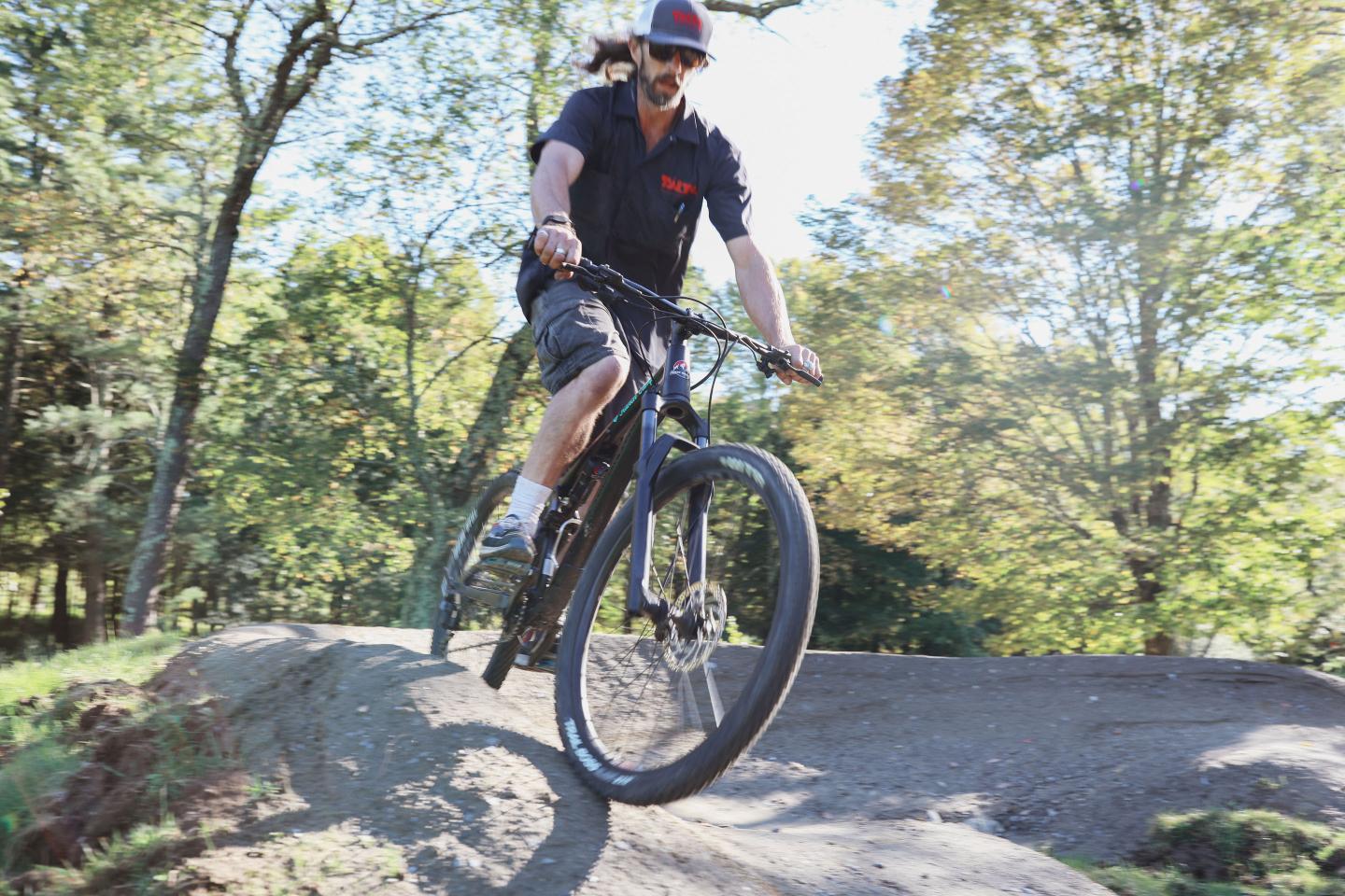 Man riding a bike on the pump track at Tälta Lodge