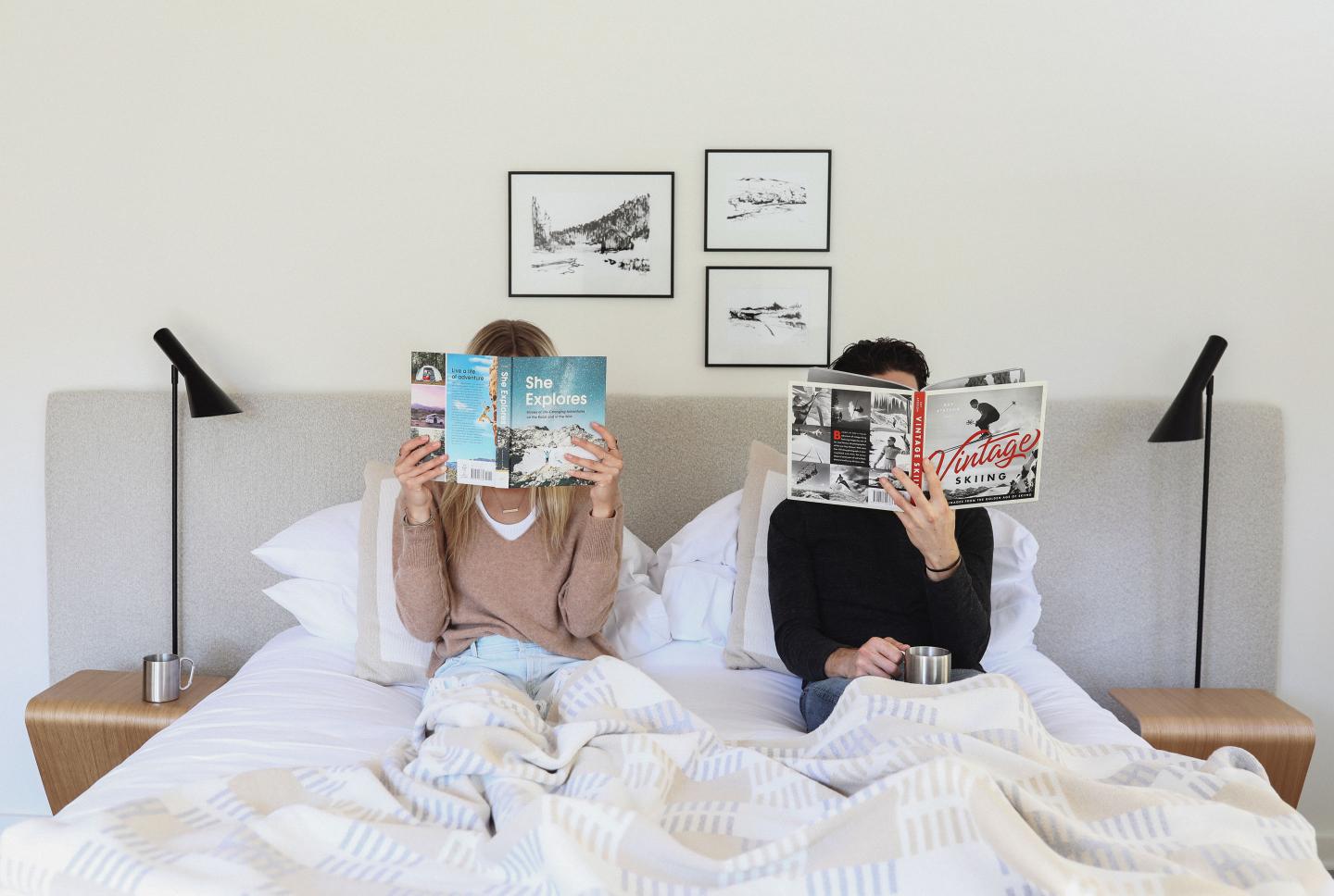 Guests relaxing in bed in their room at Tälta Lodge