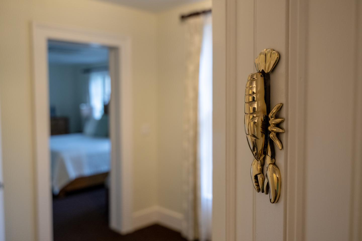 Entance to hotel guestroom with a golden door knocker