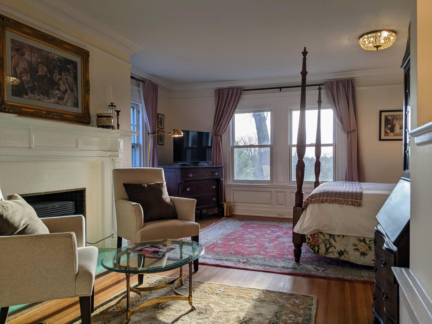 Fireplace, king bed, and sitting area of the Brush Suite