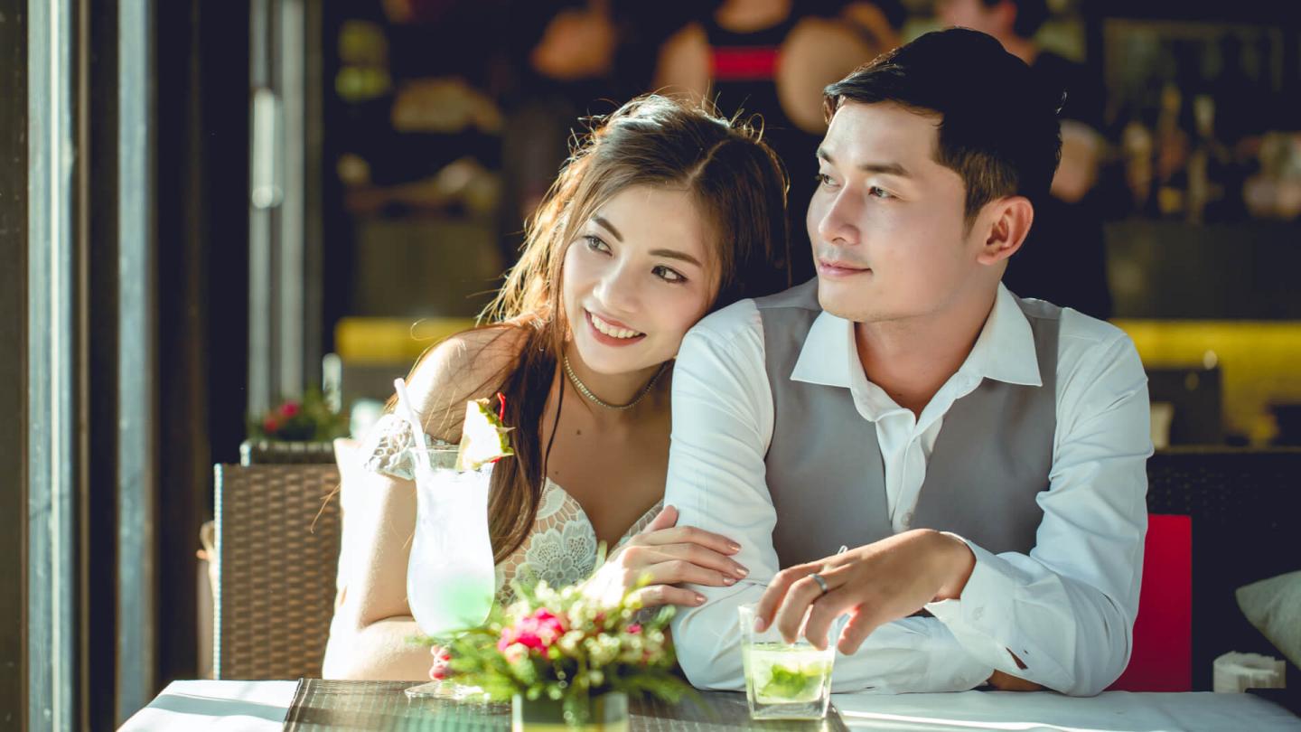 Romantic couple celebrating cocktails in the city