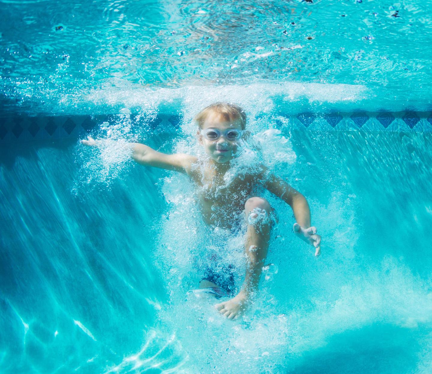 Boy jumping in pool