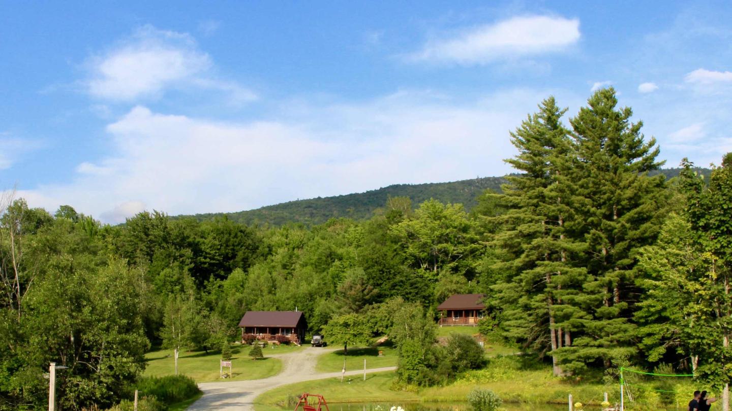 Cabins and a beautiful blue sky with puffy clouds at Sterling Ridge Resort