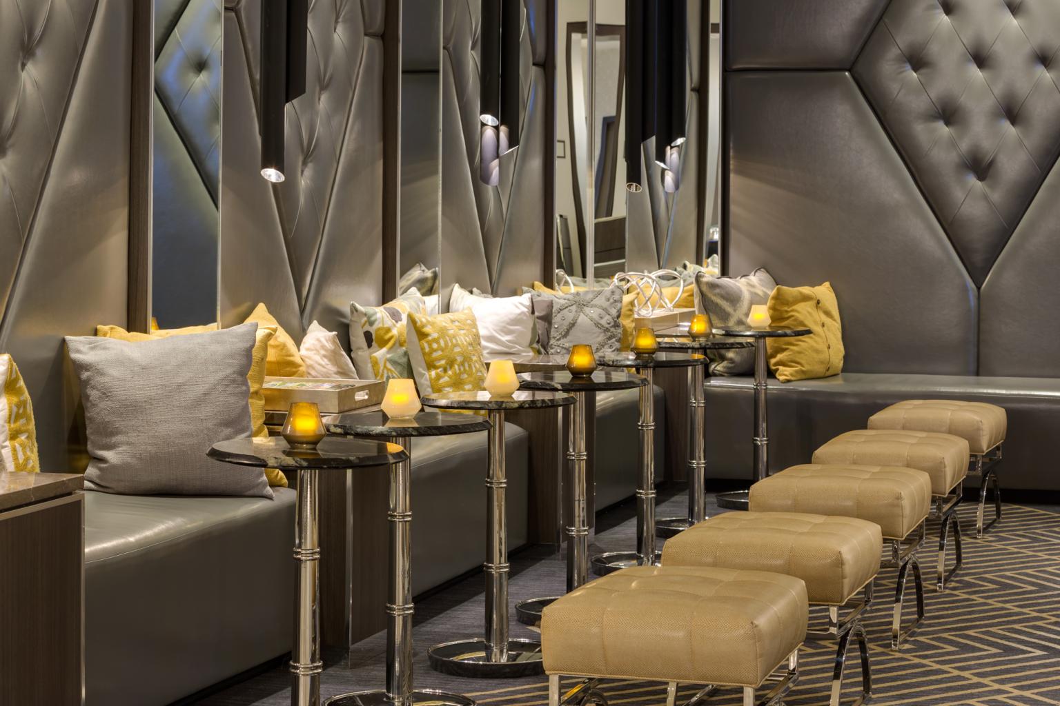 The sitting area in the lobby, has couches, tables and stools