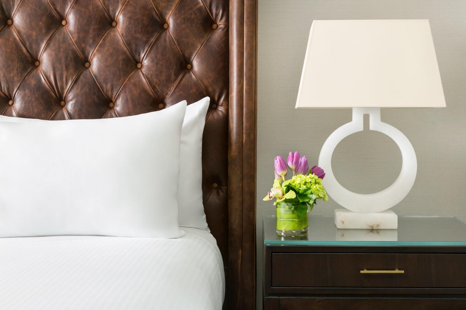 A closeup of a bed and nightstand