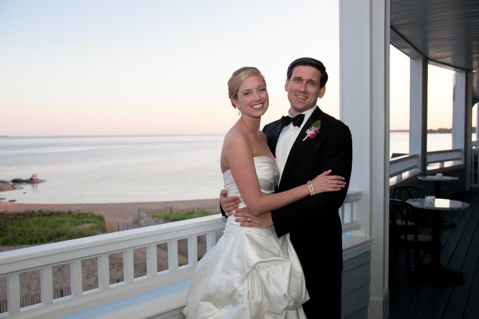 Bride & Groom on the porch at Madison Beach Hotel