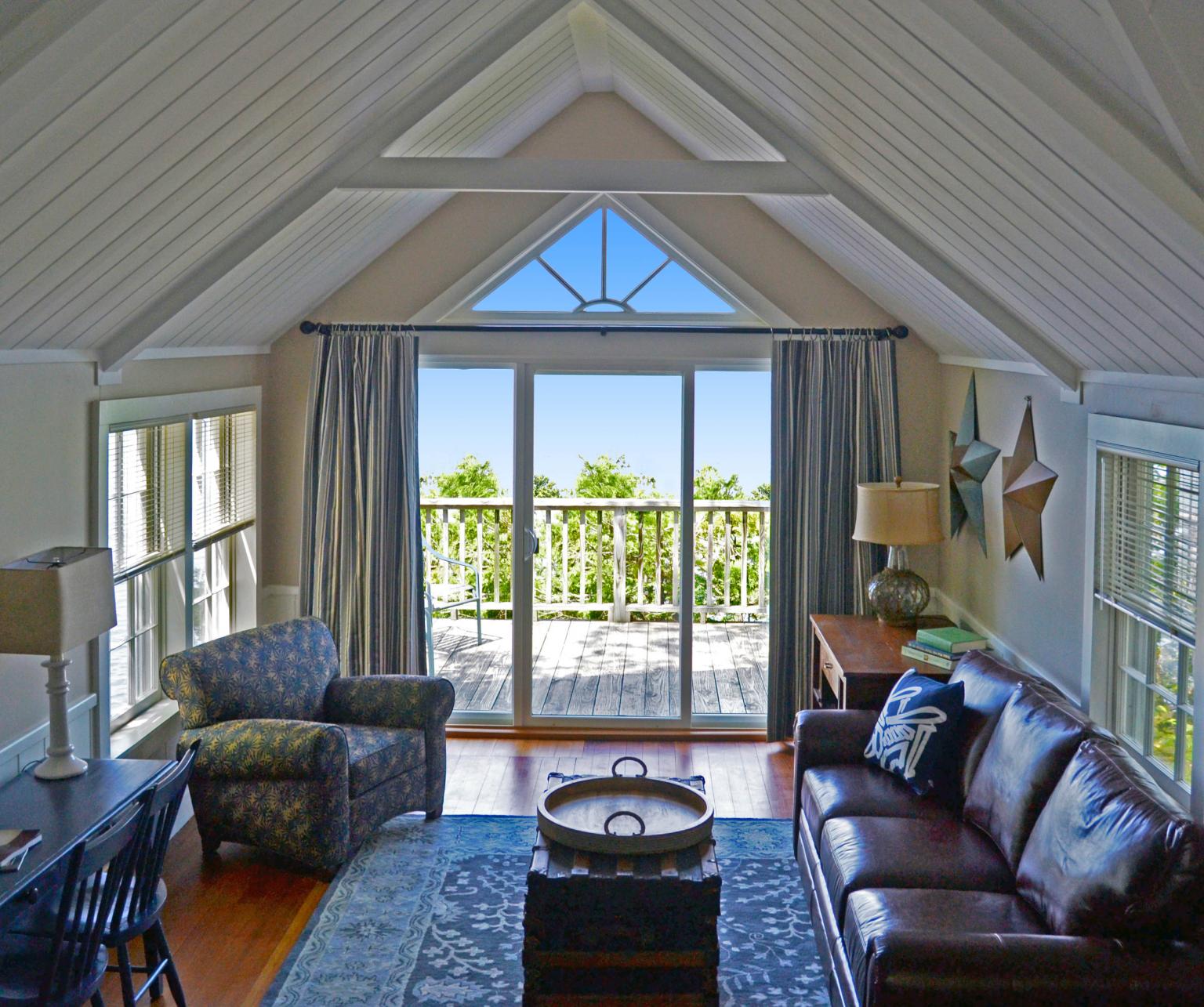 Living area of one bedroom cottage looking out at Lake Champlain