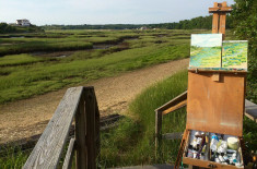 Painting easel set up on the edge of a marsh