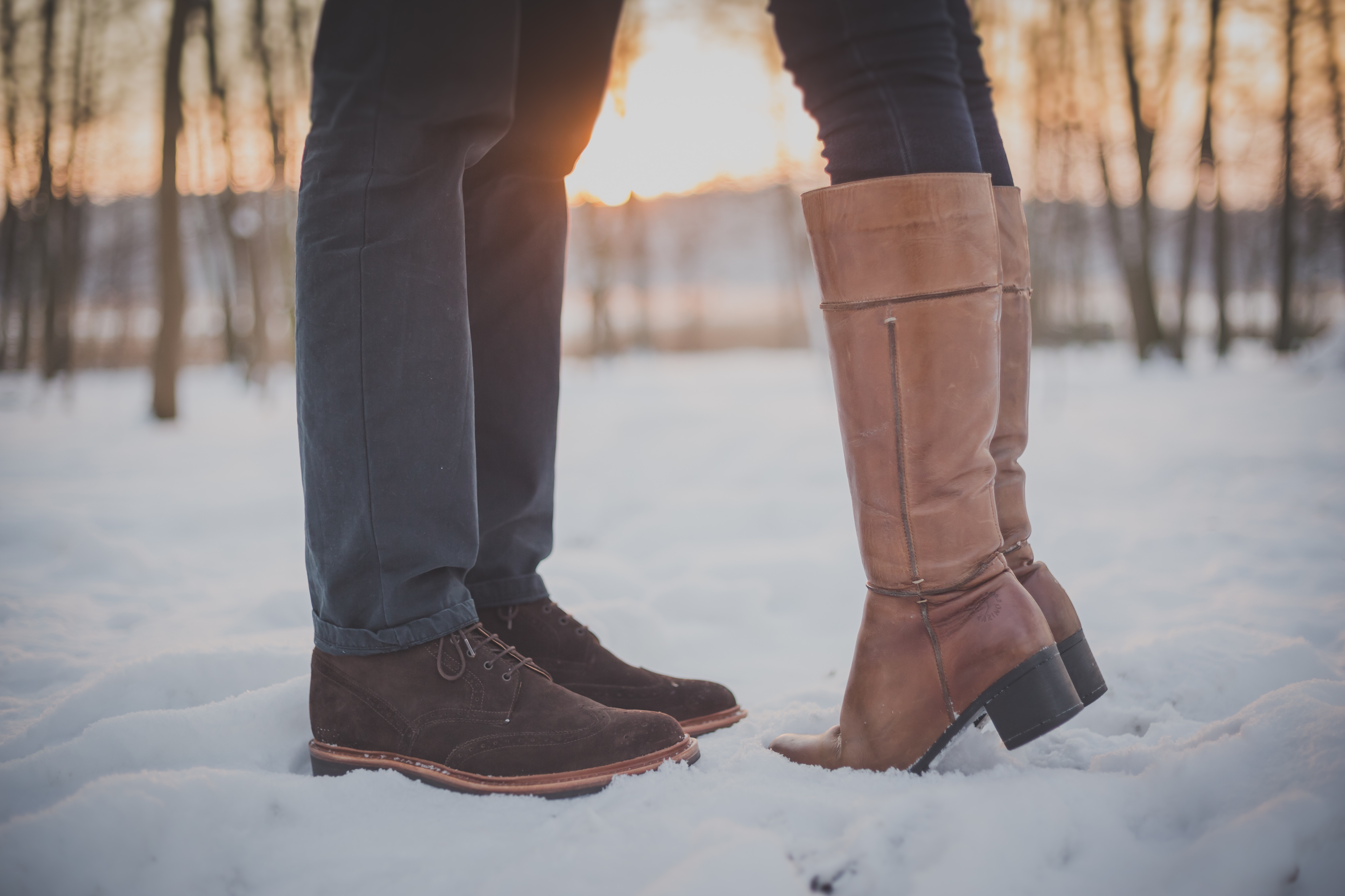 A couple standing in the snow on a Valentine's Day getaway.