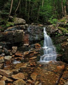 A charming stream in Lincoln, NH, nestled in the western White Mountain region.